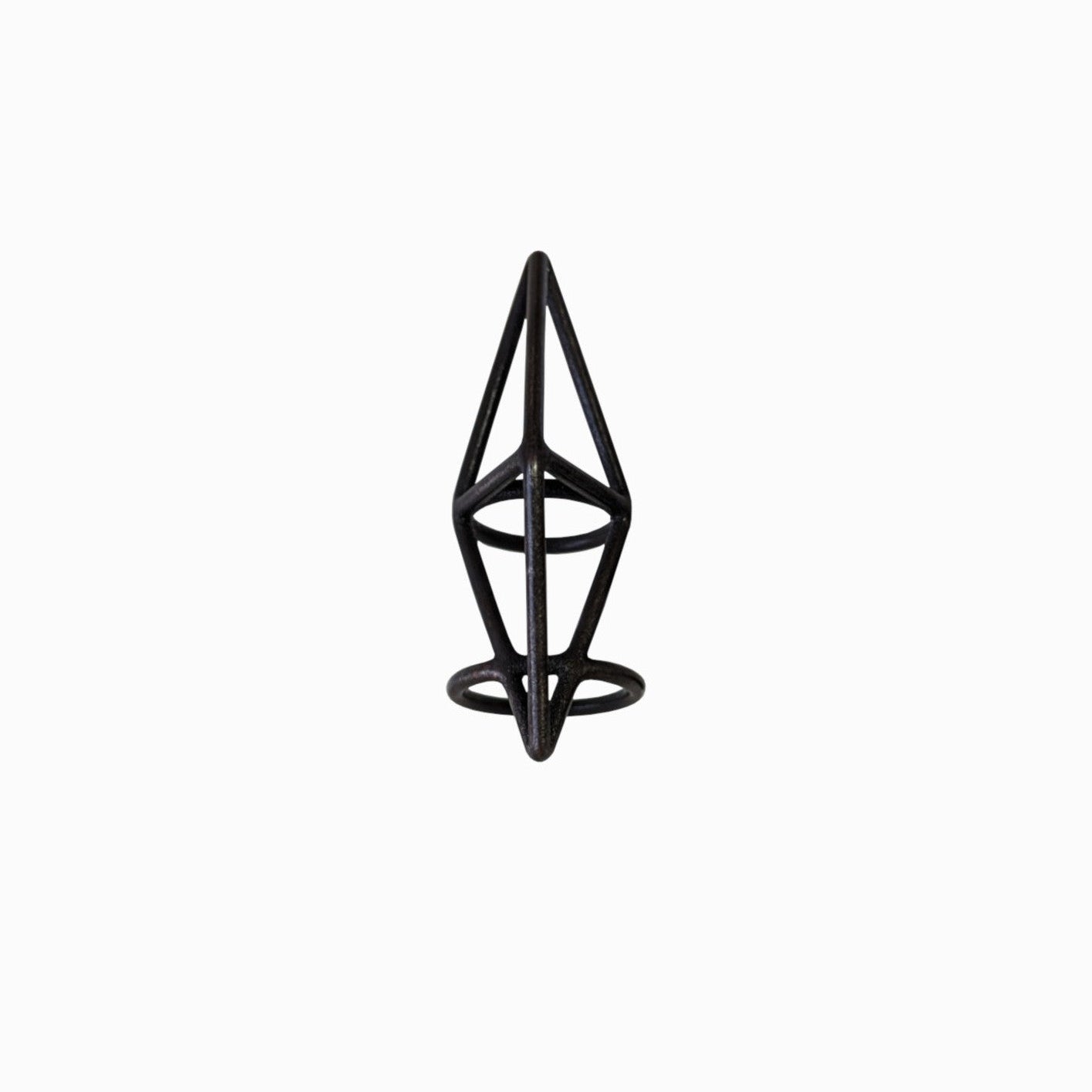 A black geometric ring resembling an abstract pyramid with circular bases, set against a plain white background.