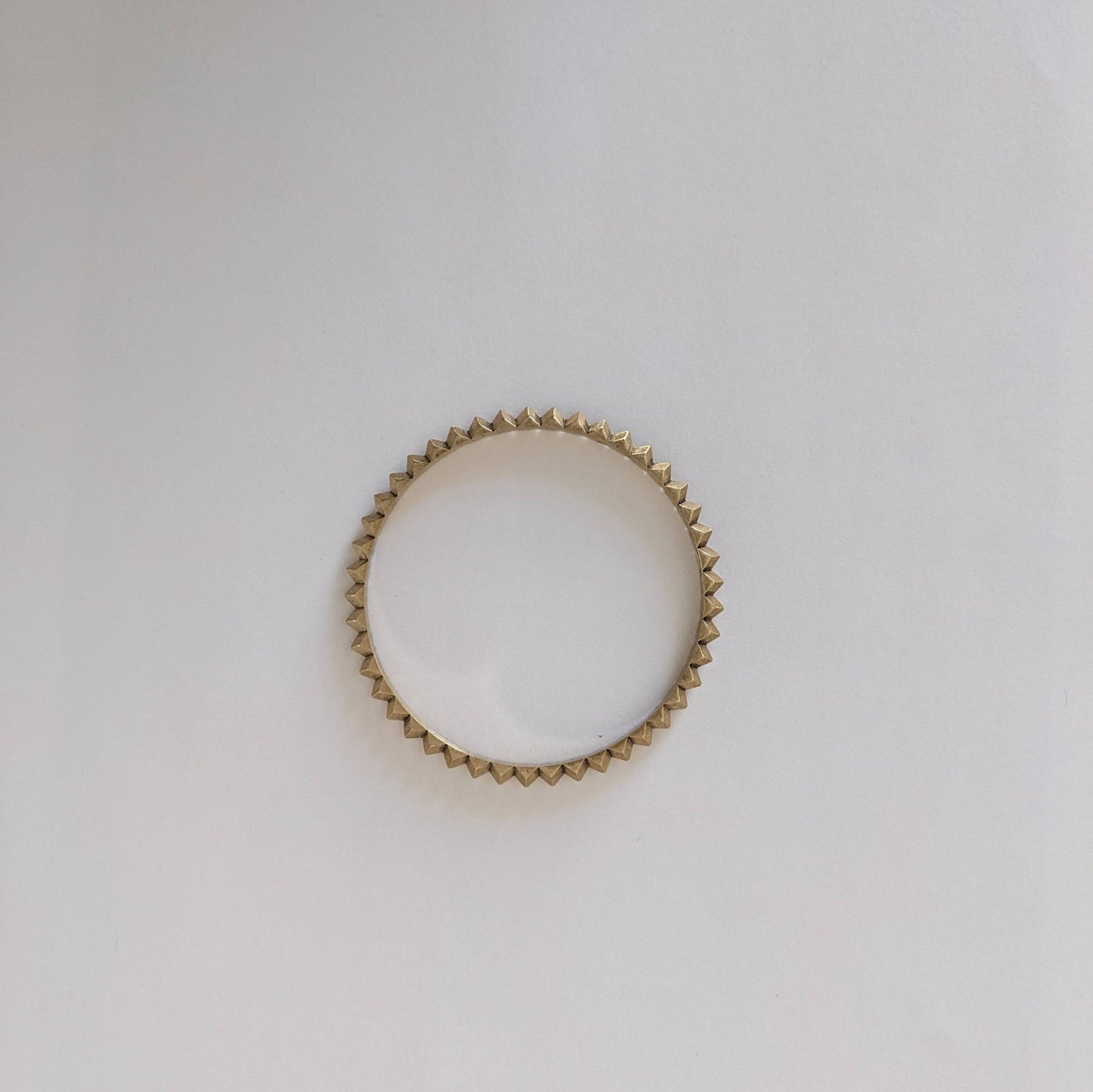 Gold ring on a light gray background