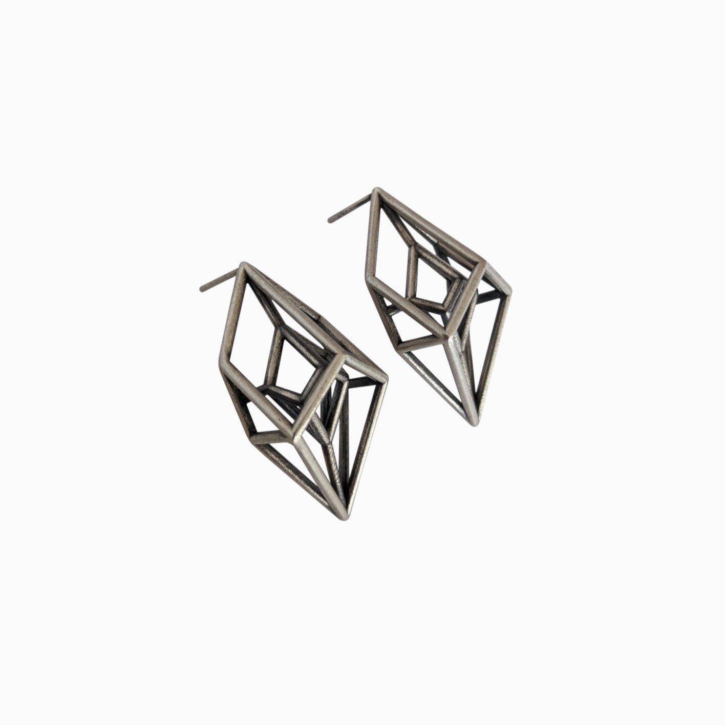 A pair of metallic geometric earrings with an intricate, angular design, showcasing a modern and artistic style.