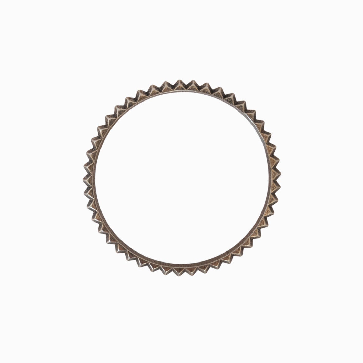 Circular bronze ring with a zigzag edge design, set against a plain white background.