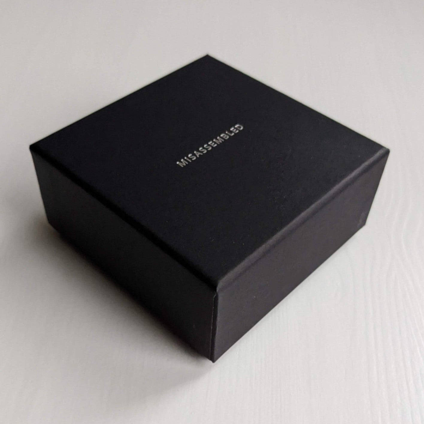 Black cardboard box with the word