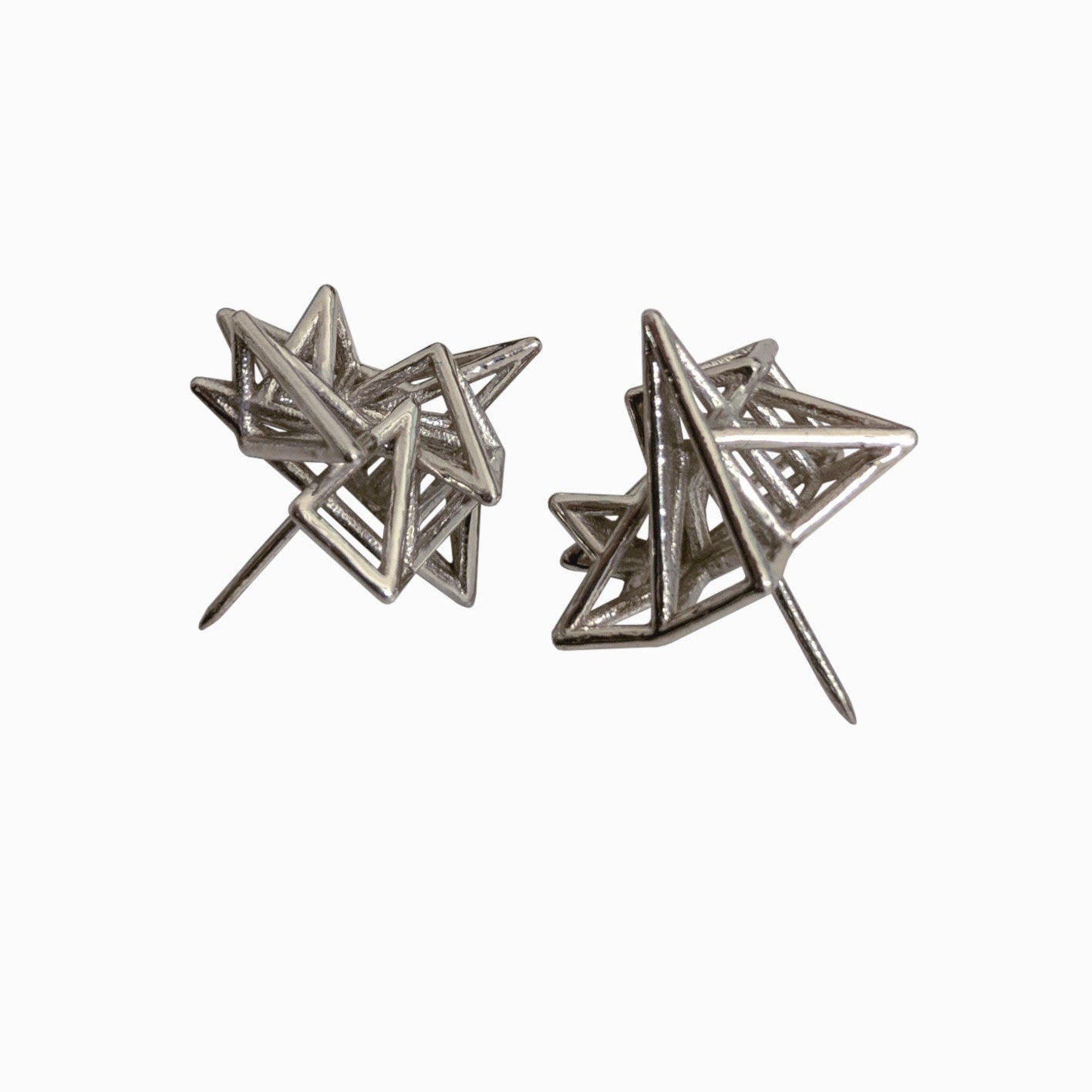 Two metallic star-shaped earrings with intricate geometric patterns, showcasing a modern and artistic design.