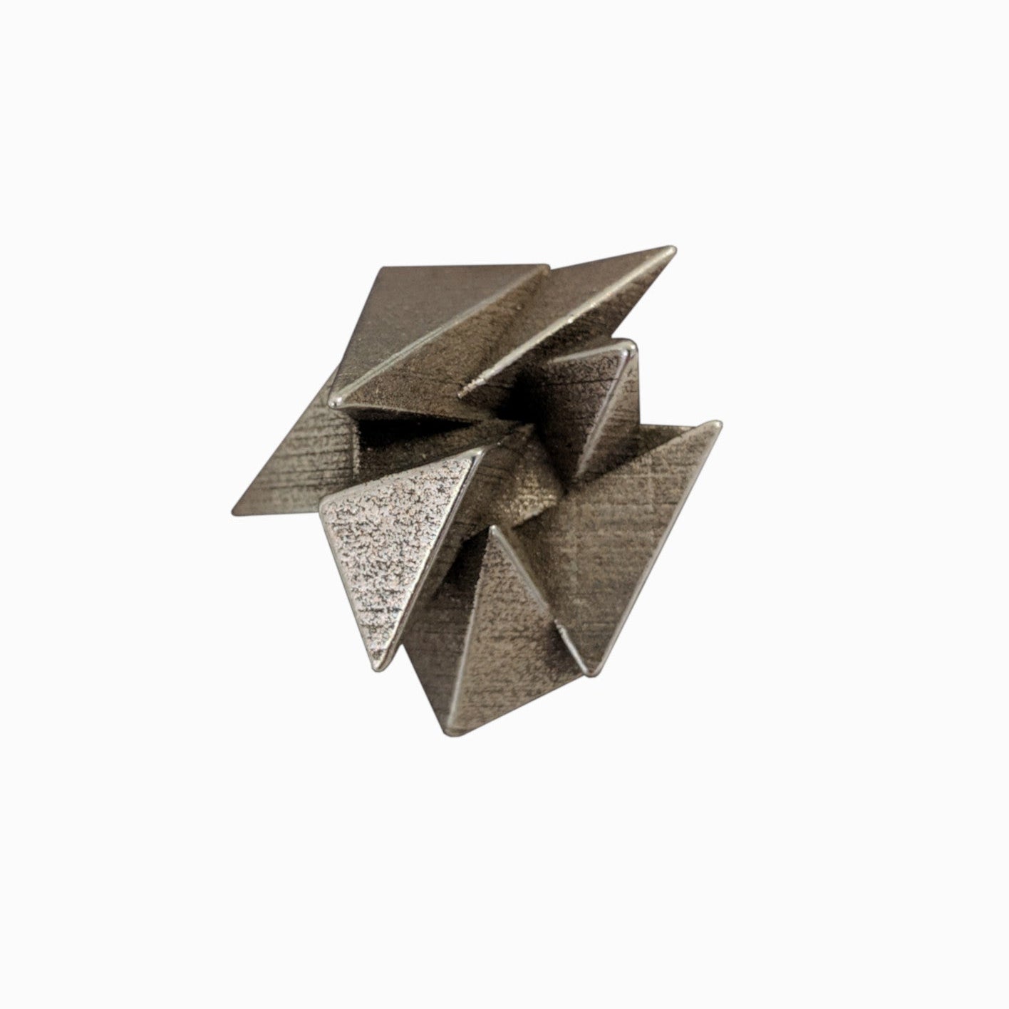 A metallic sculpture featuring interconnected triangular shapes, creating a dynamic, three-dimensional design with textured surfaces.