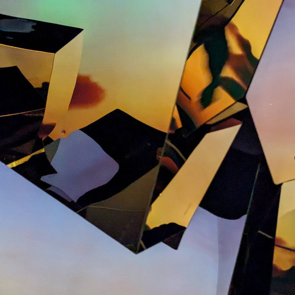 Abstract, colorful reflections and angles of geometric glass shapes, creating a vibrant interplay of light and shadow.
