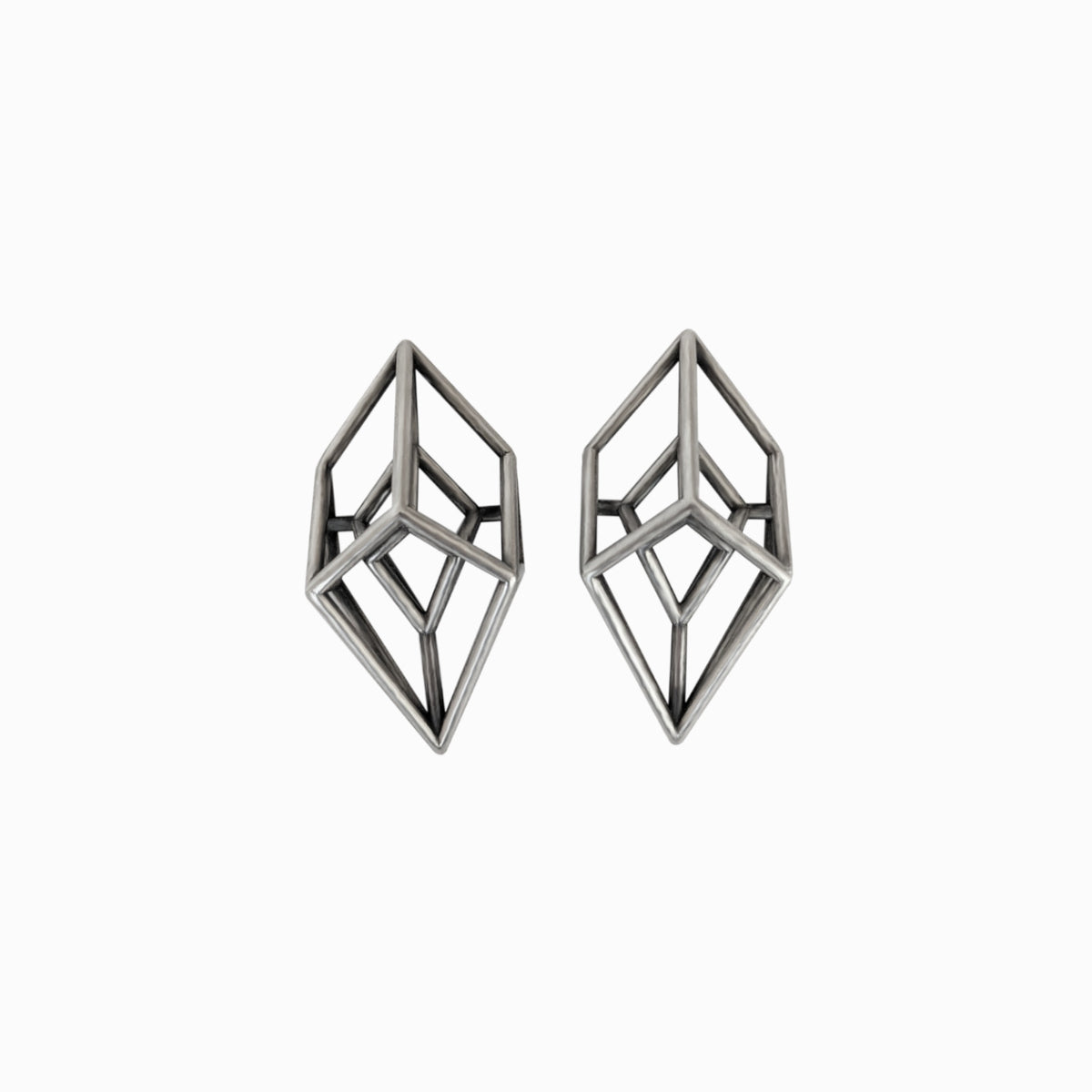Two geometric silver earrings with a modern, angular design resembling three-dimensional crystals.