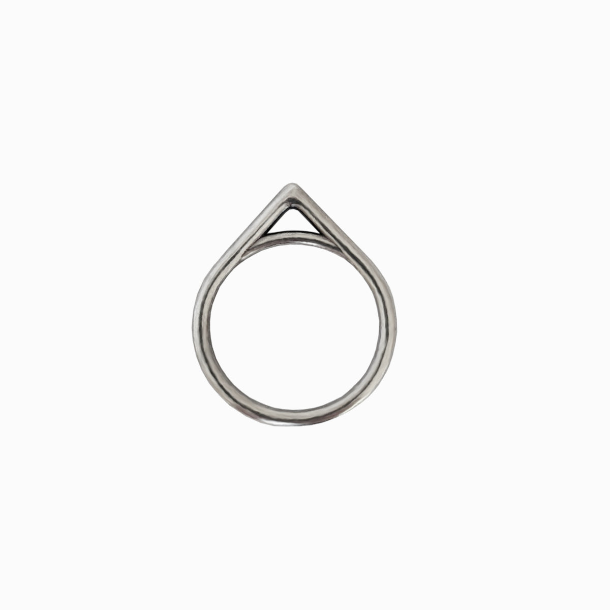A minimalist silver ring featuring a teardrop-shaped outer frame with an open triangular top and a single continuous band, shown against a plain white background.