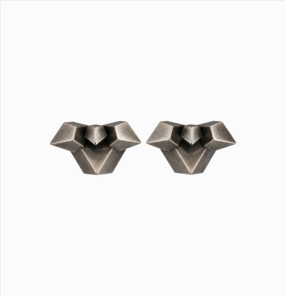 A pair of geometric stud earrings with a textured, oxidized silver finish, displayed on a clean white background.
