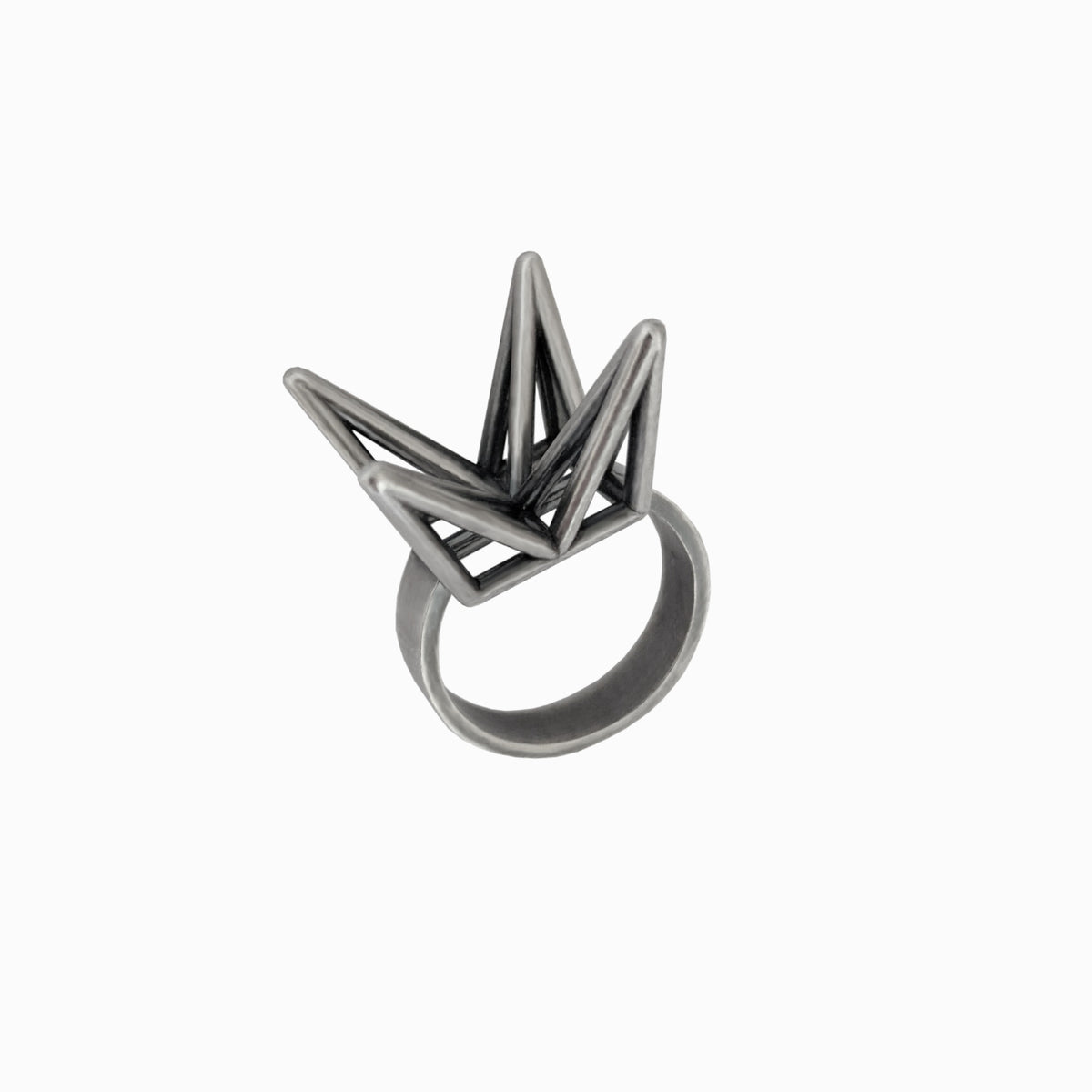 A geometric crown-shaped ring made of dark gray metal, shown on a plain white background.