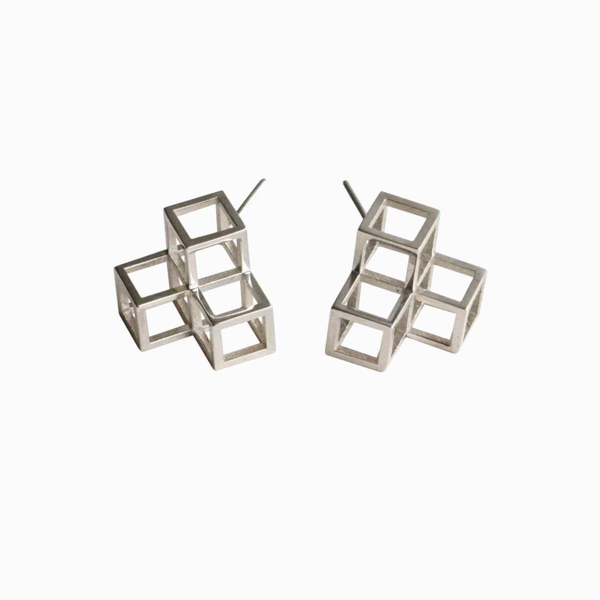 A pair of silver geometric stud earrings featuring a three-dimensional open cube design, displayed on a clean white background.