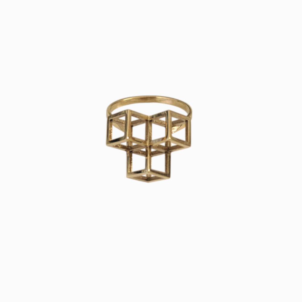 Geometric gold ring featuring a 3D cube design, elegantly crafted with open face and structured patterns.